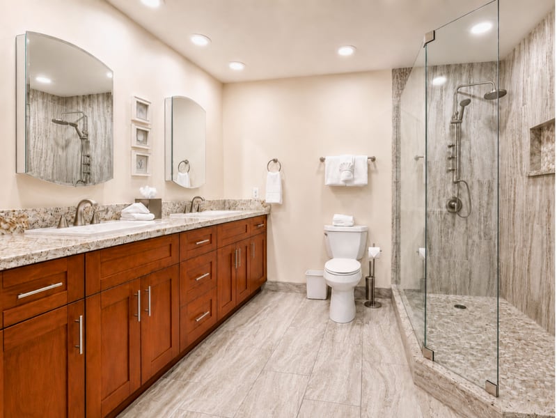 The primary bath offers two vanities beneath arched mirrors plus a separate glass shower, giving you extra room to get ready.