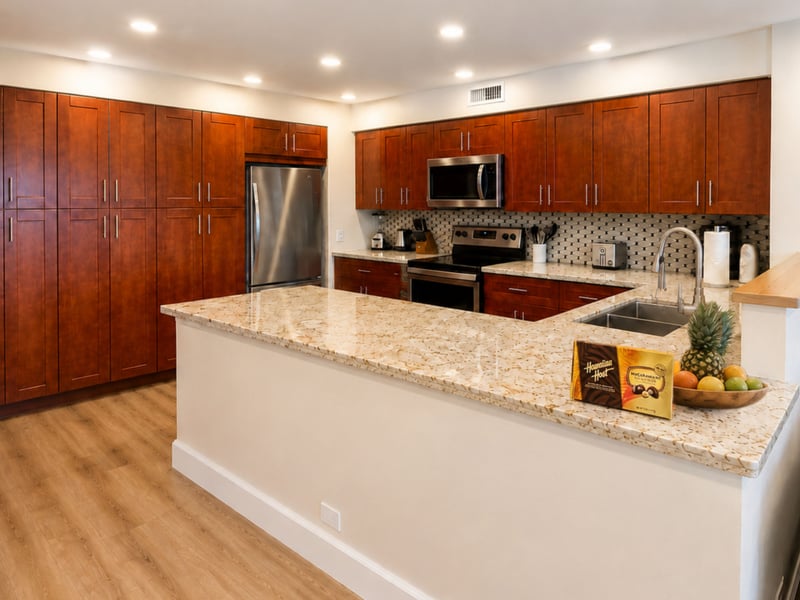 Floor to ceiling cherry cabinetry and a full size stainless refrigerator line the kitchen, giving you real storage for longer stays and group meals.