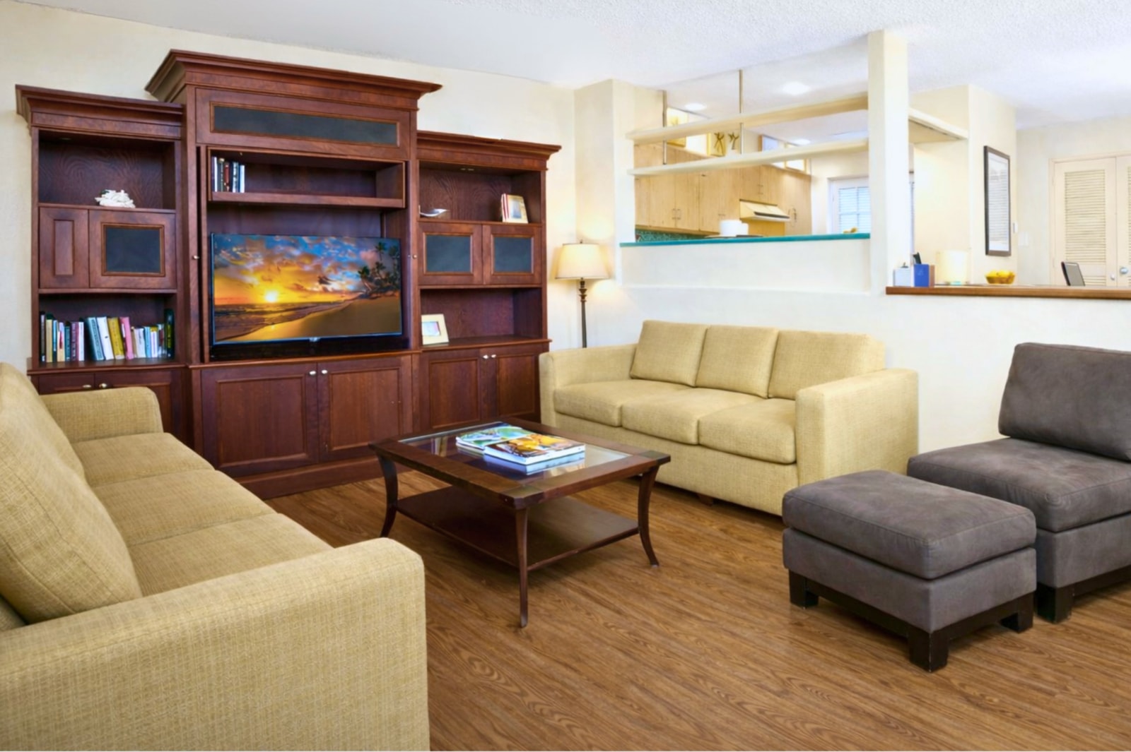 Sunlight spills over soft sofas and island tales, as palms peek in from a view kissed by aloha   
