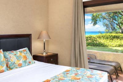 A botanical beauty with lanai access, garden glow, plush bedding, and stylish wood furnishings all around