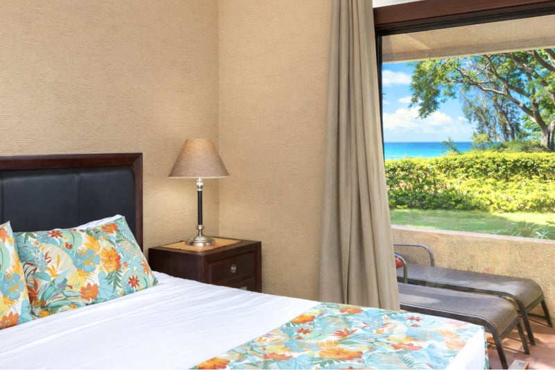 A botanical beauty with lanai access, garden glow, plush bedding, and stylish wood furnishings all around