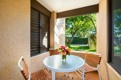 A charming, sheltered lanai surrounded by greenery—perfect for quiet mornings or relaxed open-air meals