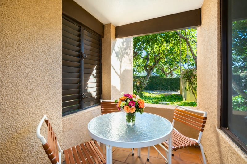 A charming, sheltered lanai surrounded by greenery—perfect for quiet mornings or relaxed open-air meals