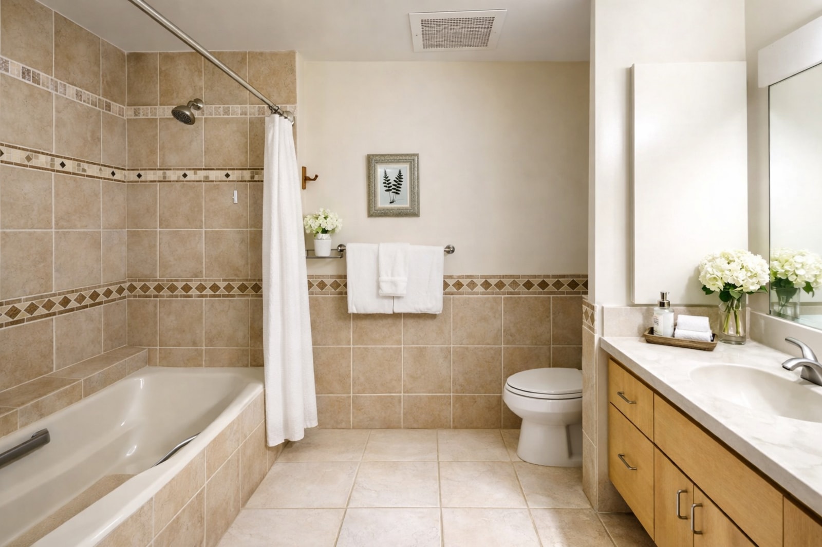    The deep soaking tub is framed by classic border tile and topped with a rainfall-style showerhead for spa-like versatility