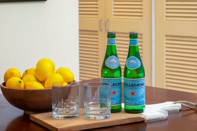 A welcoming touch of zest and sparkle—fresh lemons and chilled San Pellegrino set the mood for island indulgence