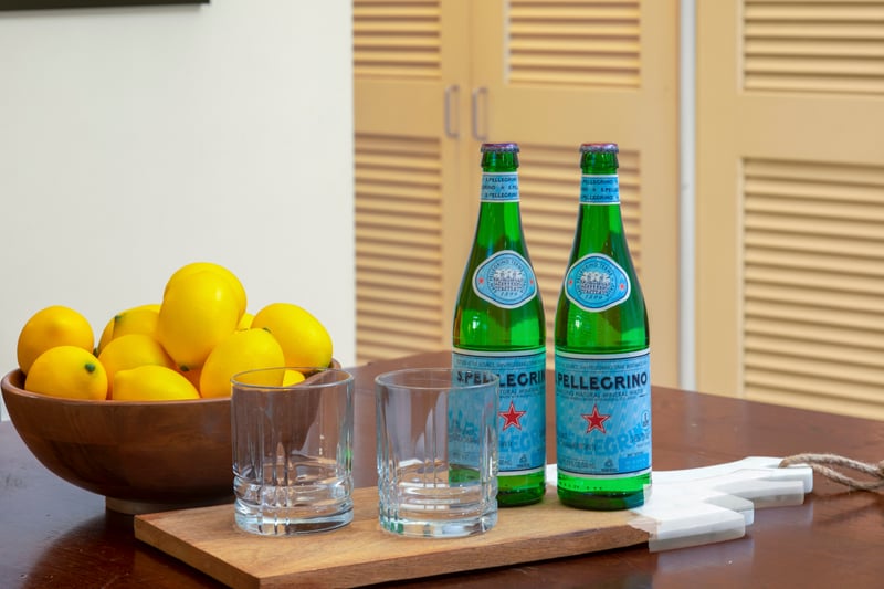 A welcoming touch of zest and sparkle—fresh lemons and chilled San Pellegrino set the mood for island indulgence