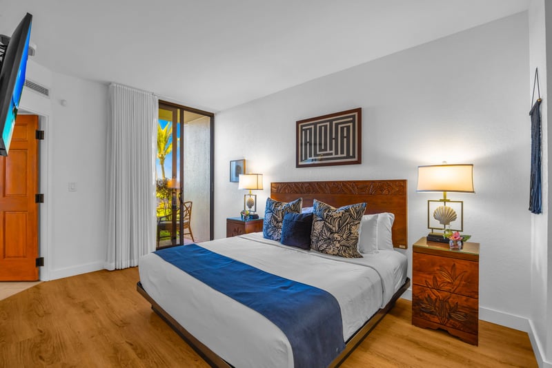Wake up refreshed in the stunning primary bedroom, where comfort meets breathtaking tropical surroundings