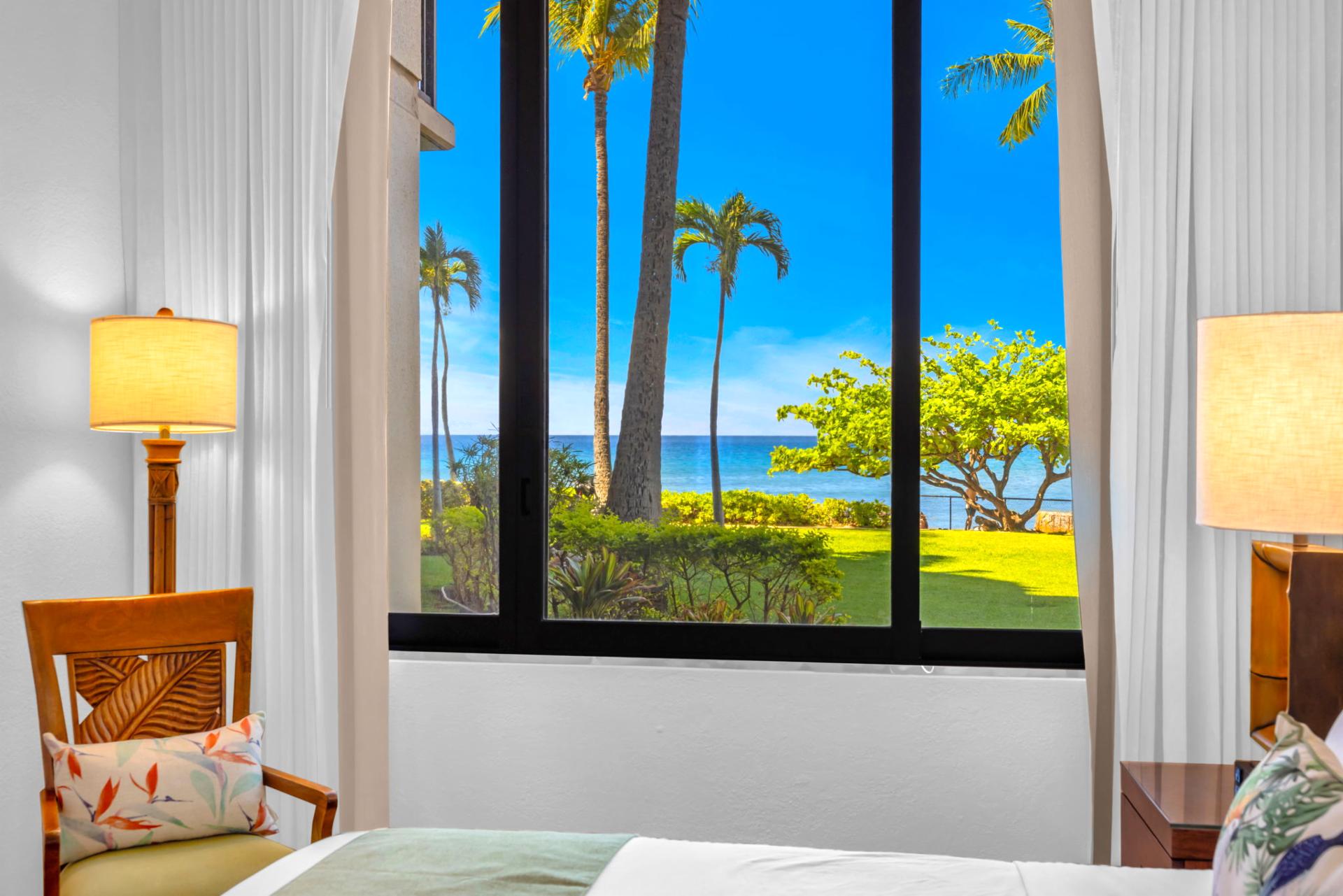 The sunlit guest bedroom features gorgeous views