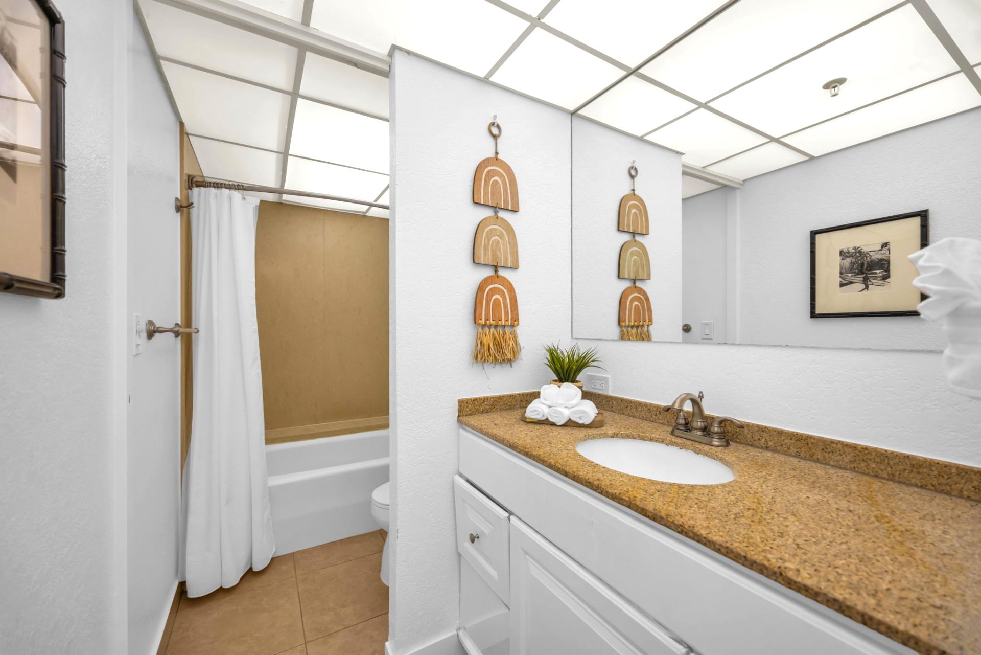 The spa-inspired ensuite bathroom features island decor and ample counter space
