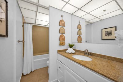The spa-inspired ensuite bathroom features island decor and ample counter space KS-104