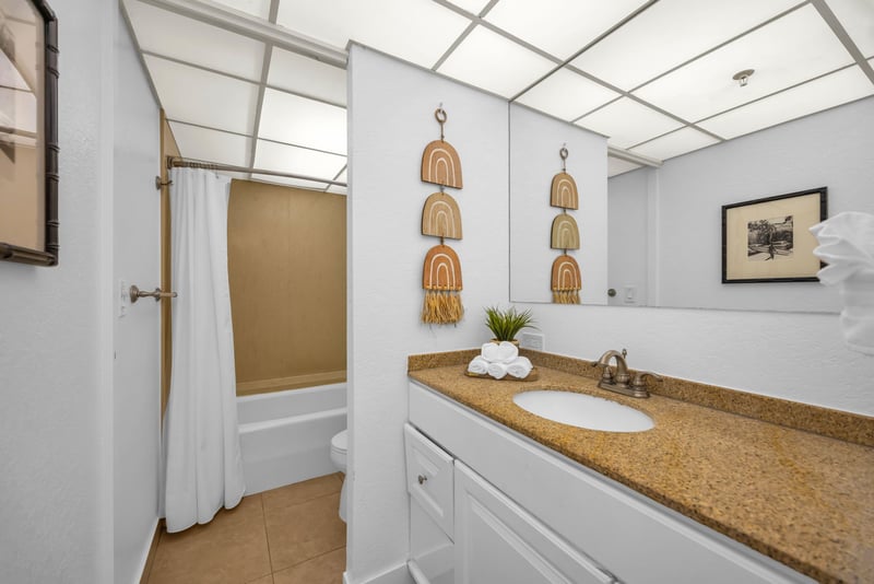 The spa-inspired ensuite bathroom features island decor and ample counter space