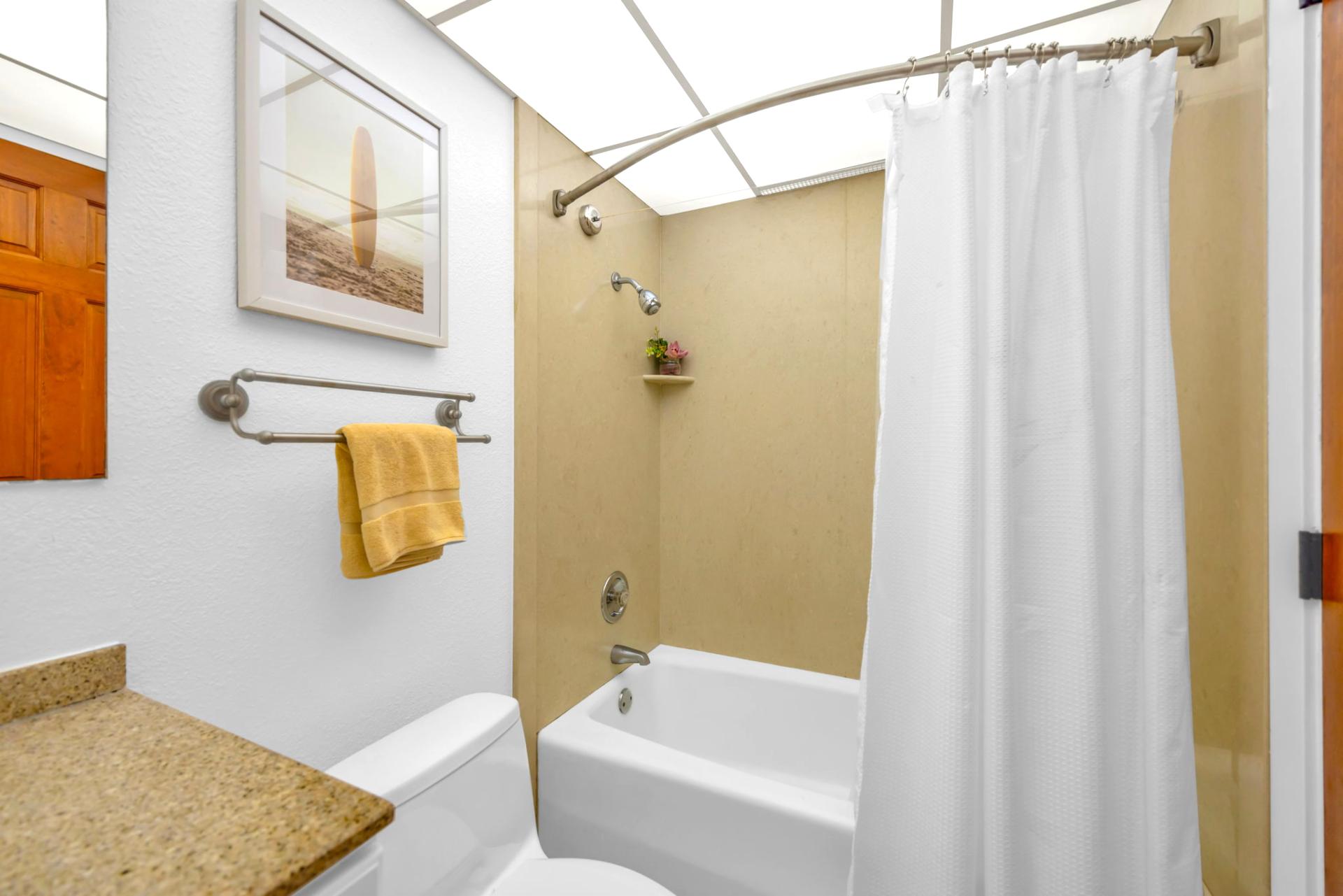 The guest bathroom features a tub to unwind in after a day exploring the island