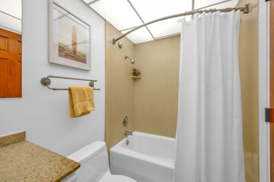 The guest bathroom features a tub to unwind in after a day exploring the island