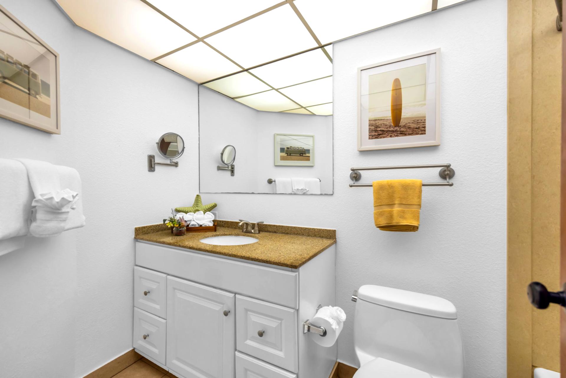 The pristine guest bathroom features a clean, spa-like aesthetic
