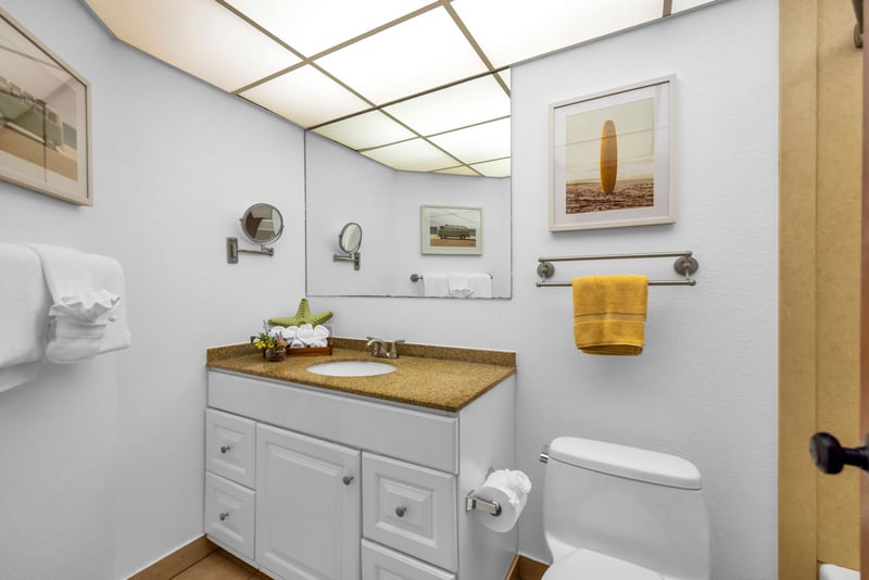 The pristine guest bathroom features a clean, spa-like aesthetic