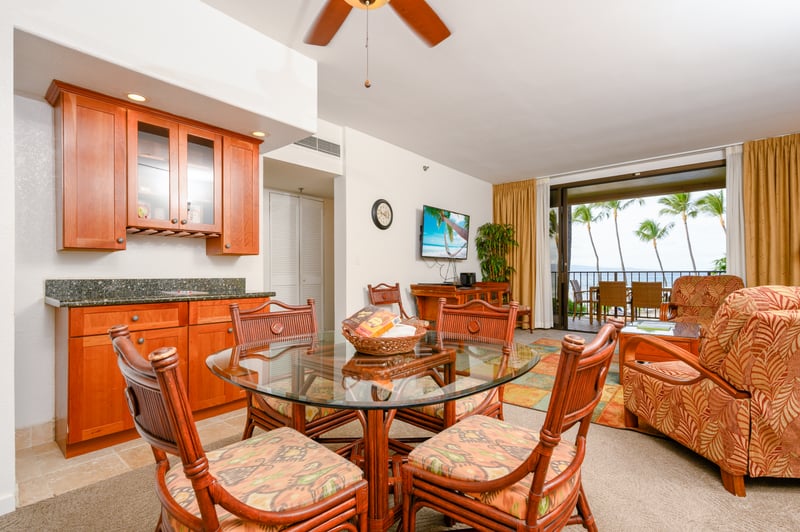 Glass tops shimmer, rattan chairs invite, and ocean light pours in—this dining nook hums with island ease and joy KS-258