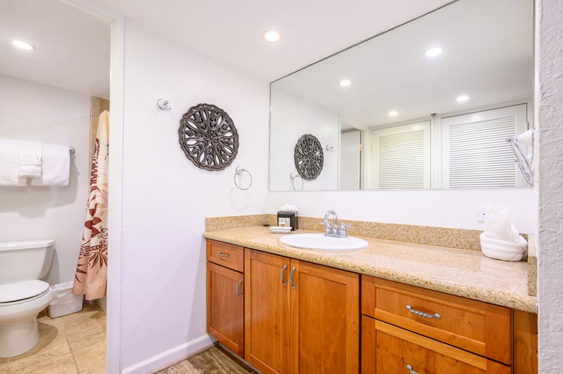 Grounded by warm wood cabinetry and soft stone countertops, the vanity offers both function and a welcoming, earthy elegance KS-258
