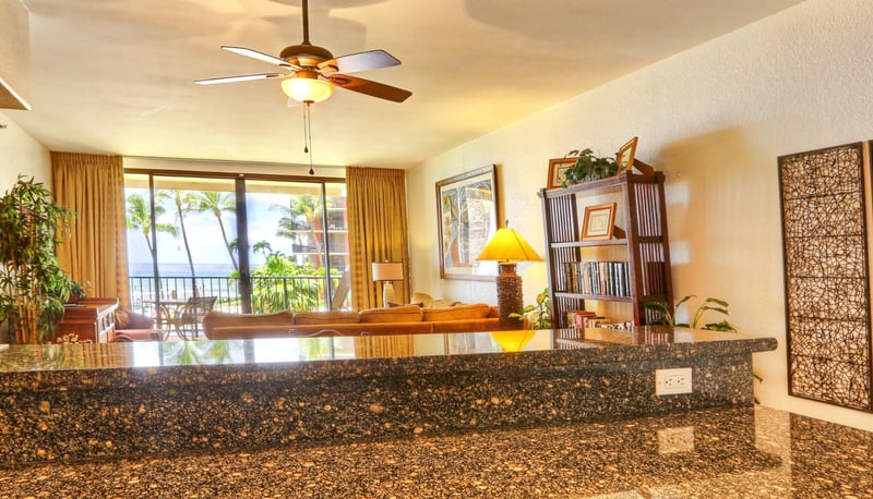 Chop, stir, and sip in a kitchen kissed by palm views, amber cabinets, and glossy granite that steals the spotlight KS-258