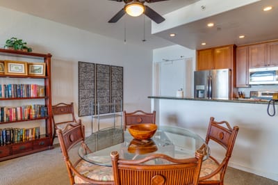 Tropical wood tones and breezy fans set the stage for cozy meals, beachy chats, and carefree island-day planning