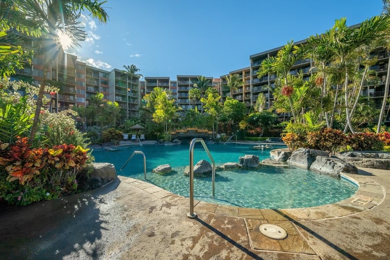 Lush tropical serenity surrounds this sparkling resort pool paradise.
