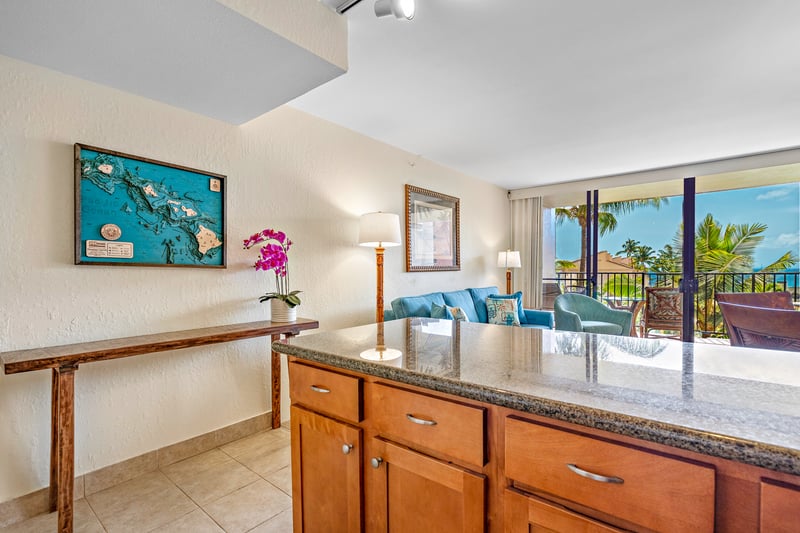 This cozy kitchen pairs golden wood tones and granite sparkle with island art and breezy views made for morning magic KS-535