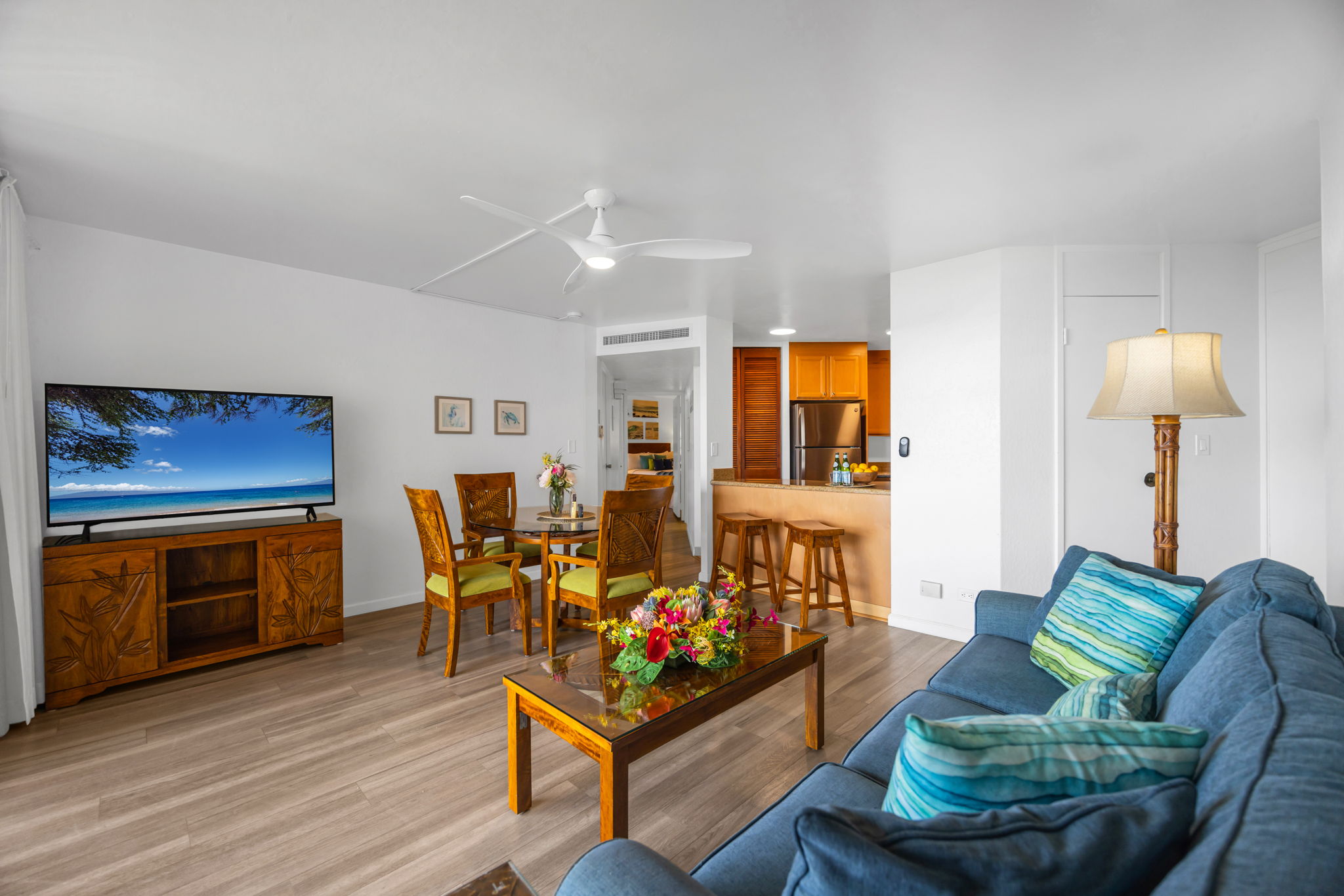 Spacious open layout with island-inspired furnishings, a large Smart TV, and breakfast bar seating just off the fully equipped kitchen. KS-616