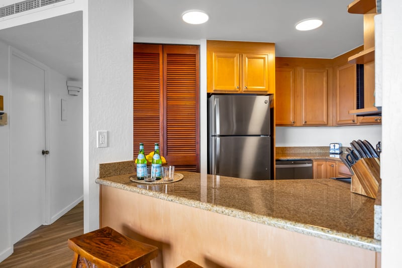 Granite breakfast bar and full-size stainless steel appliances offer everyday ease in this fully equipped kitchen.