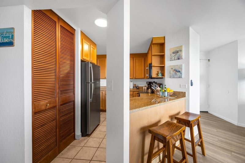 The kitchen features granite counters, bar seating, and full-size appliances, ideal for quick breakfasts or easy meals at home.