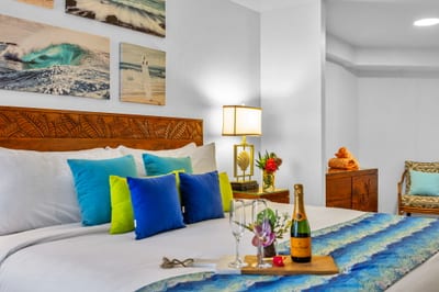 Colorful accents and carved wood details bring island charm to this King bedroom retreat, perfect for honeymooners or a celebratory getaway.