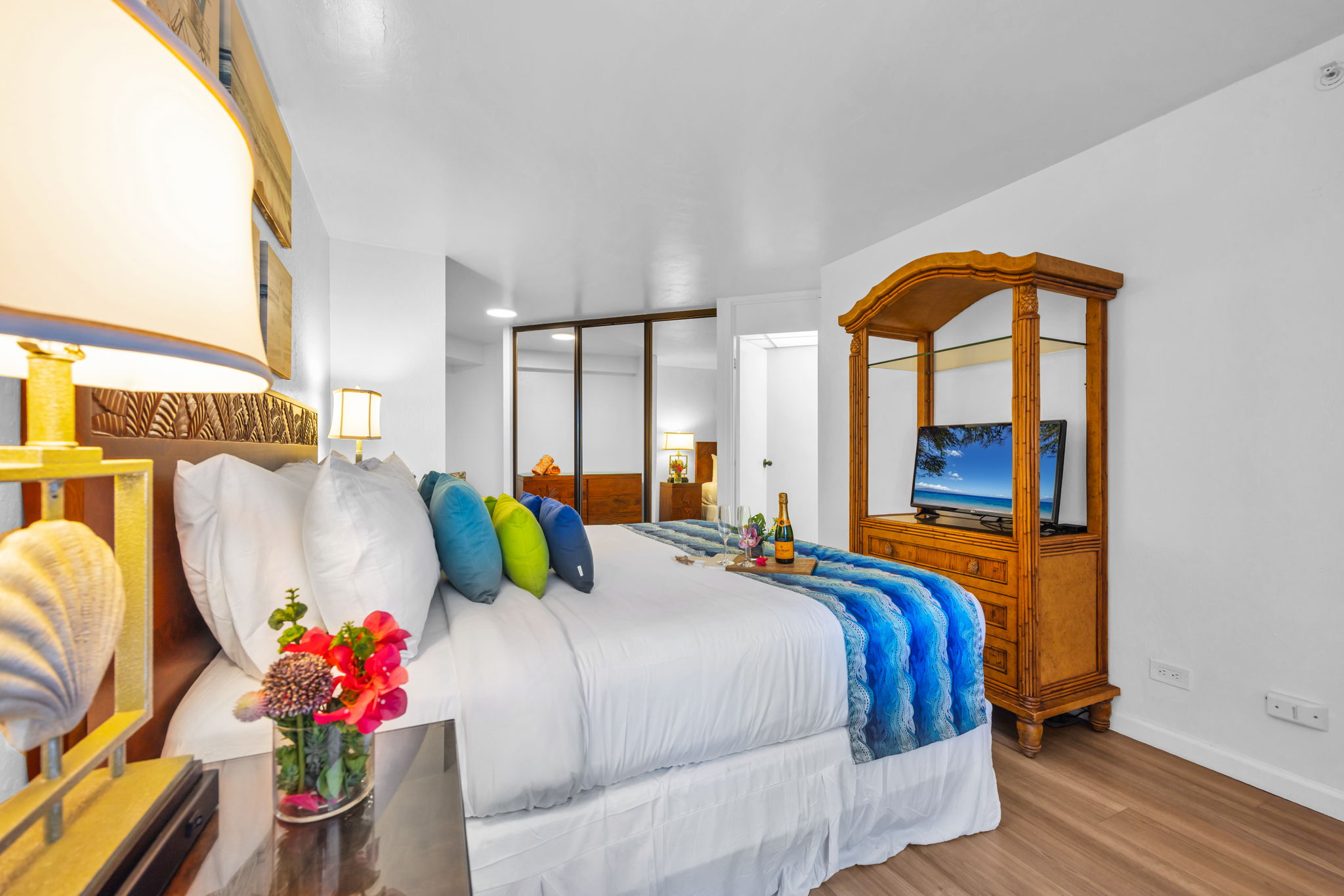 King bedroom with mirrored closet, flat-screen TV, and tropical hardwood furnishings for a comfortable and inviting island escape. KS-616