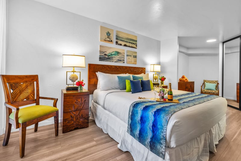 Well-appointed King bedroom with tropical wood accents, mirrored closet, and soft lighting for a restful retreat after sun-soaked island days.