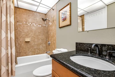 Framed by warm sage walls and grounded in rich granite, the vanity offers a quiet sense of comfort and everyday elegance