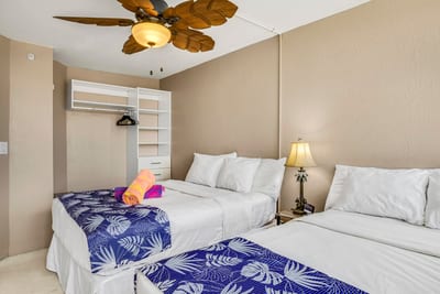 Double the comfort, double the fun—this guest room shines with palm flair, lanai access, and closet space to spare