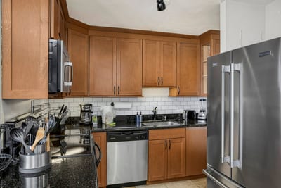 This kitchen pairs warmth and polish—where dark countertops, subway tiles, and sunshine make every bite feel brighter