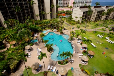 Gaze down from your lanai to a palm-lined pool paradise—where sunshine, splash time, and smiles await
