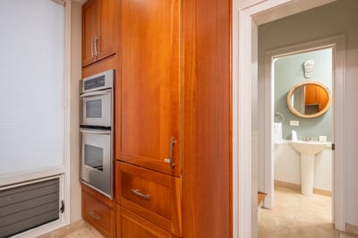 Warm wood cabinetry and neutral granite counters create a welcoming kitchen perfect for cooking and conversation KBV-12B3