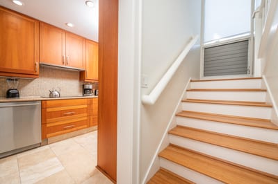 A soft and welcoming staircase with matching wood tones connects the lower level with tranquil flow upstairs KBV-12B3