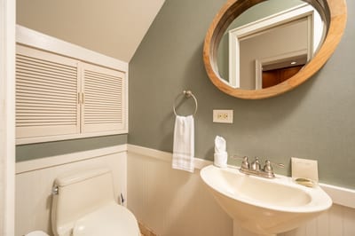Elegant finishes and vintage charm blend beautifully in this cozy, well-appointed guest bathroom