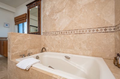 From the custom tilework to the spa tub and vanity seating, this bathroom is tailored for restful luxury KBV-12B3