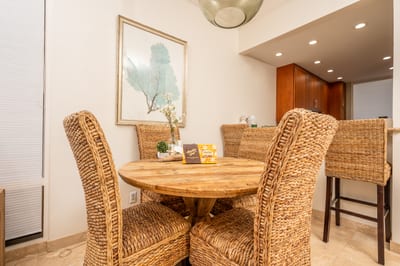 Gather around a handwoven rattan dining set nestled beneath soft pendant lighting, just steps from the ocean breeze KBV-12B3