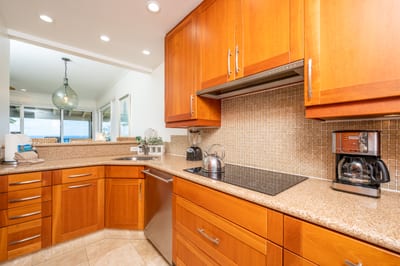Double built-in ovens make hosting easy, and the hallway leads to a chic powder room for added convenience KBV-12B3
