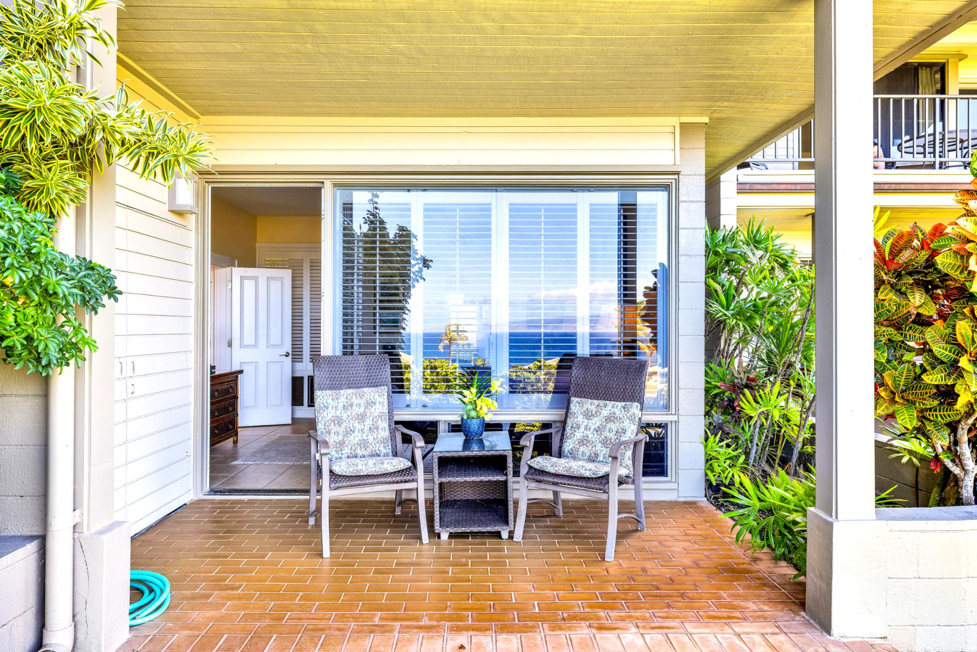The primary bedroom features a cozy private lanai, perfect for gazing out at the ocean