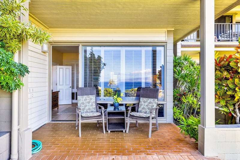 The primary bedroom features a cozy private lanai, perfect for gazing out at the ocean