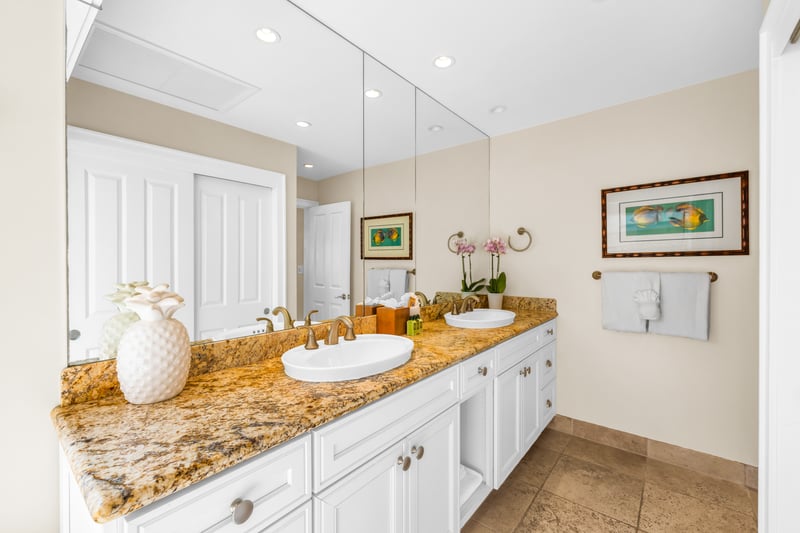 Clean and bright guest bathroom featuring a double vanity for convenience