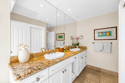 Clean and bright guest bathroom featuring a double vanity for convenience