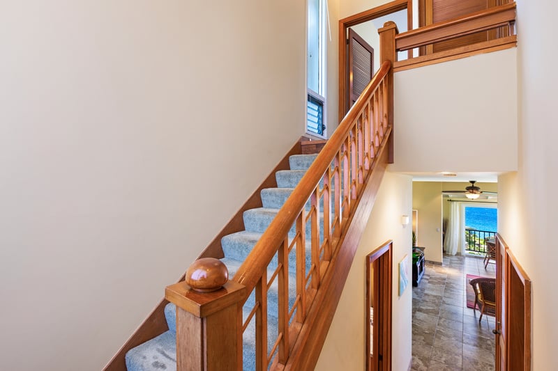 Elegant wooden stairs lead you into a light-filled, thoughtfully designed space