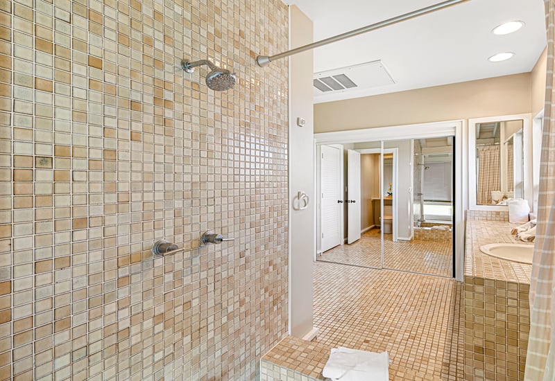 Indulge in a morning routine surrounded by mosaic tile, coastal charm, and sunlit elegance     