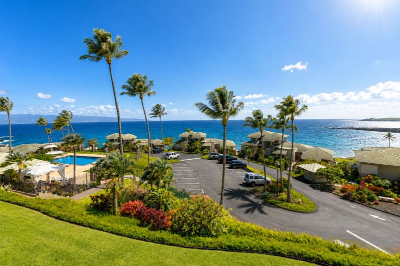 Kapalua Bay Villas' oceanfront pool and grounds sit just below your building, with the West Maui coastline stretching along the shore.
