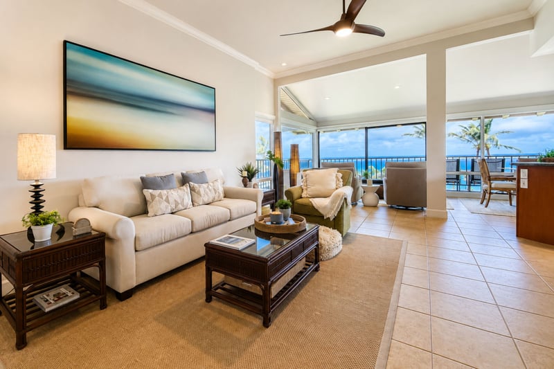 A second seating area connects your living room to the lanai and dining table, keeping the ocean-view space open from end to end.