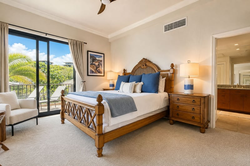 Your primary bedroom pairs a king bed with direct lanai access, framed by palm trees and a partial ocean view.